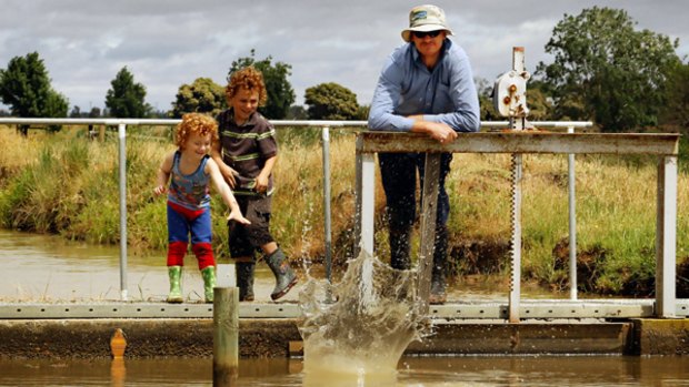 Dairy farmer  Leon Peace  with sons  Oliver (left) and Austin at the channel that services his farm near Cohuna, in the state's north.