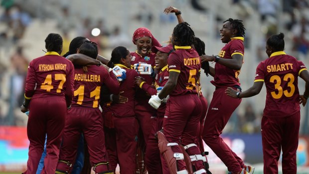 West Indies players celebrate winning the Women's ICC World Twenty20 final against Australia at Eden Gardens.