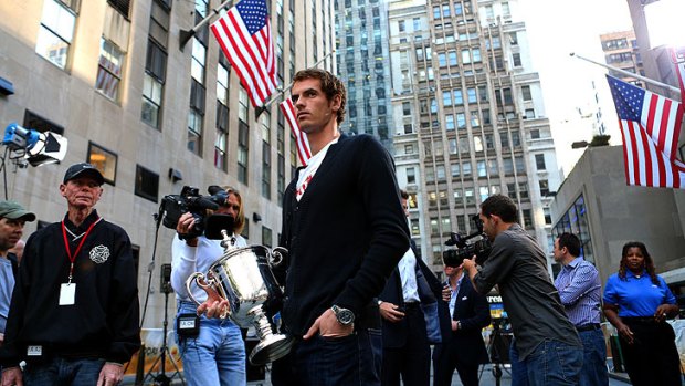 Smiling on the inside ... Andy Murray with his US Open trophy at a photocall in New York overnight.