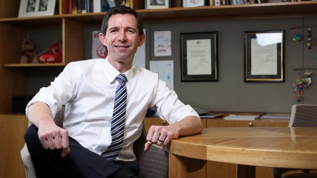 Simon Birmingham, Minister for Education and Training, just before getting "HECS LYFE" tattooed on his knuckles.
