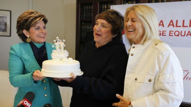 Icing on the cake: Diane Olson, right, and her wife Robin Tyler receive a wedding cake from attorney Gloria Allred at a news conference in Los Angeles.