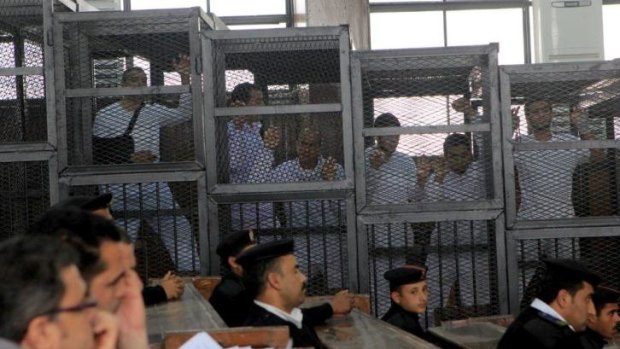 Defendants inside the cage in the courtroom.