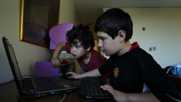 Every move they make ... Daniel Suttner, 8, and his brother Guy, 10, playing online, helpless to stop various online companies from tracking their activities.