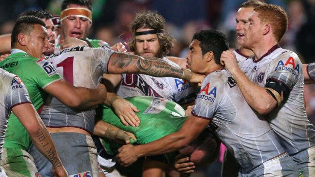 Tempers flare: Anthony Watmough and Dane Tilse have to be separated at Brookvale Oval.