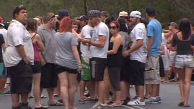 Friends of those killed in the crash at Coomera early Saturday gather where five died.