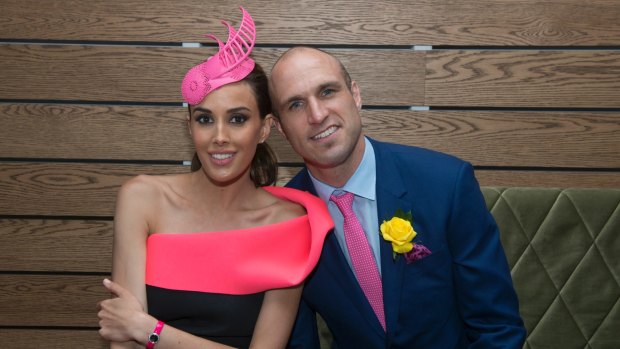 Rebecca Judd, with husband Chris, wearing a piece by de millinery at the 2013 Melbourne Cup.