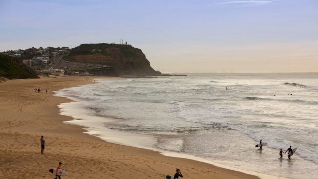 The man was rescued from the surf at Merewether Beach.