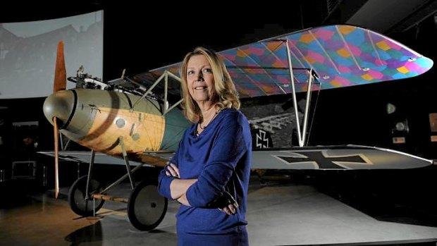 Acting director of the Australian War Memorial, Nola Andersonin front of a captured German World War I Albatross bi-plane.