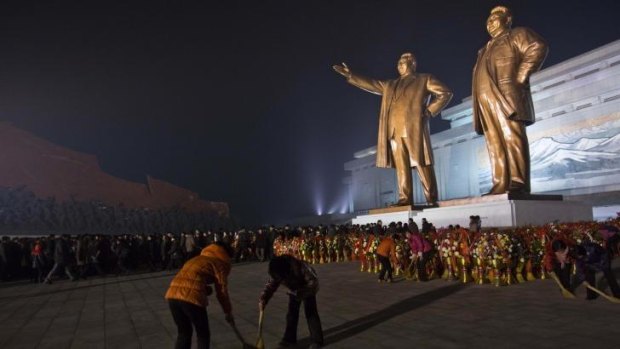 North Koreans pay their respects at the base of statues of the late leaders Kim Il Sung and Kim Jong Il, in Pyongyang, North Korea. 
