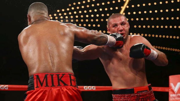 Time for a rethink: Mike Perez punches Magomed Abdusalamov during a bout which left the latter in a coma.