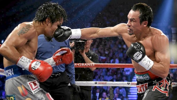Crunch ... Juan Manuel Marquez, from Mexico, right, lands a right to the head of Manny Pacquiao.
