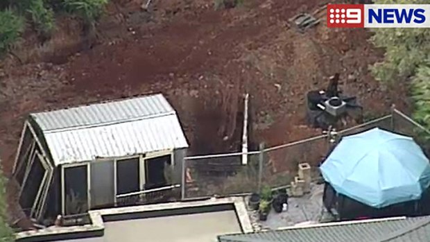 Police excavate the backyard of a Gold Coast house.