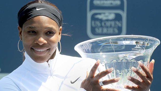 Serena Williams poses with her trophy after defeating Marion Bartoli in the final of the Bank of the West Classic in Stanford, California.