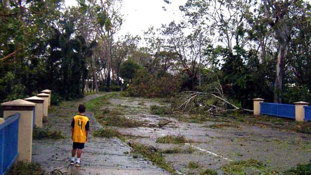 Boy inspects aftermath of Yasi in Townsville.