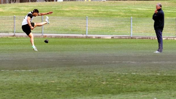 Graham Arnold oversees Benji Marshall's kicking technique at training yesterday. Marshall has worked with Arnold since 2003.