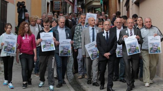 Mayor of Saint-Martin-Vesubie, Henri Giuge (first row, second from right) at a march in support of 55-year-old Herve Gourdel on Tuesday.