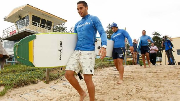 Surf's up: Corey Norman leads Parramatta players onto the beach at North Cronulla on Wednesday.