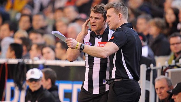 Shaw gets instructions from coach Nathan Buckley.