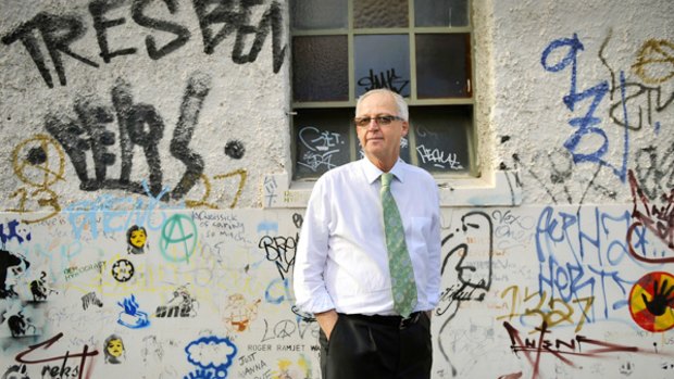 Municipal Association chief Rob Spence values the political and artistic merit of graffiti, such as the wall near his home, including a Banksy stencil work, bottom left.