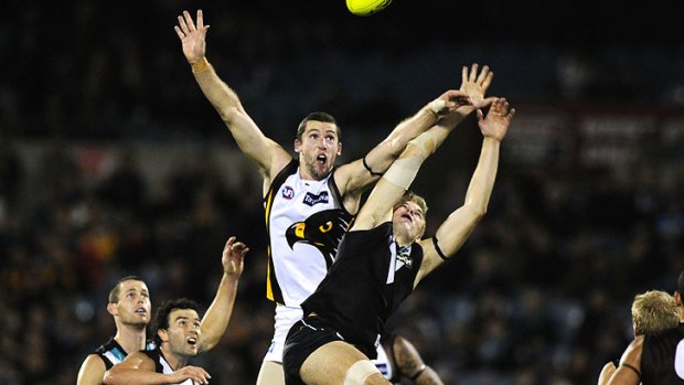 Hawthorn’s Brent Renouf and Port Adelaide’s Jackson Trengove contest the ball on Friday night.