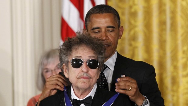 Barack Obama presents Bob Dylan with a Medal of Freedom at the White House.