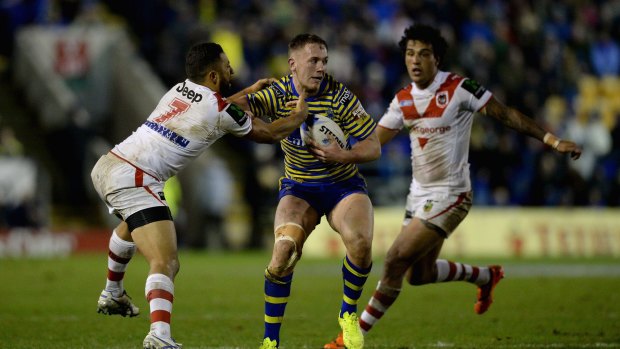 Marshall lore: Benji Marshall, left, tackles Warrington's Ben Currie.  The former Tiger scored two tries in the World Club Series clash.