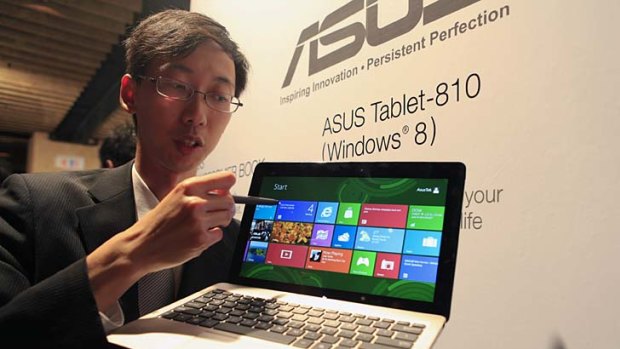 A representative demonstrates the ASUS Tablet 810 at a news conference in Taipei, Taiwan, on Monday, June 4, 2012.