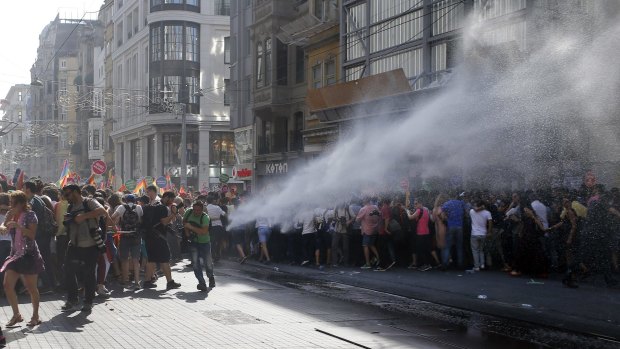Turkish police use a water canon to disperse participants at Istanbul's Gay Pride parade. 
