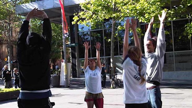 Demonstrators exercising at Martin Place this morning.