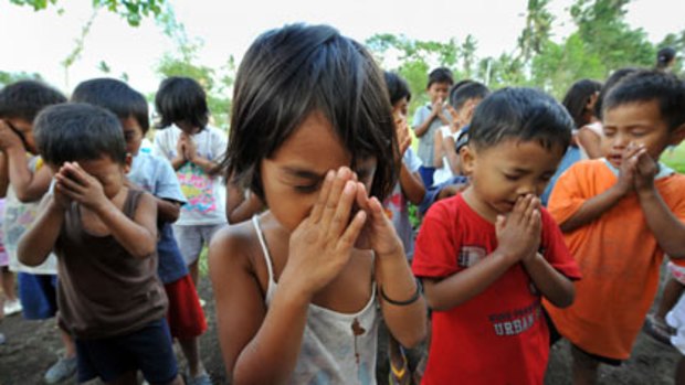 Prayers...young evacuees pray in a shelter.