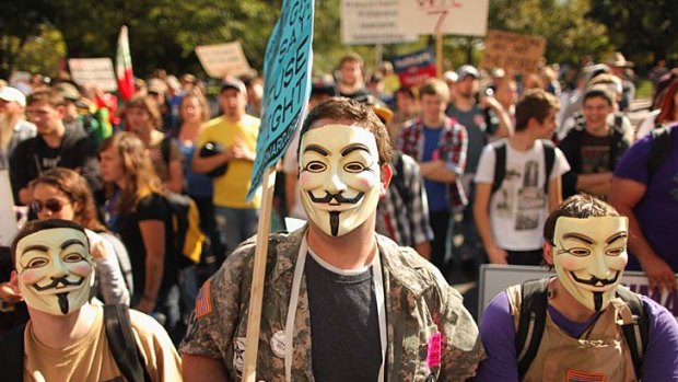 Veterans don Guy Fawkes masks while demonstrating in front of the US Chamber of Commerce in Washington, DC.