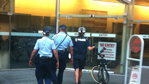 Police enter the court complex in Brisbane's CBD, evacuated on Thursday as lawyers for accused murderer Gerard Baden-Clay appeared to make a bail application.