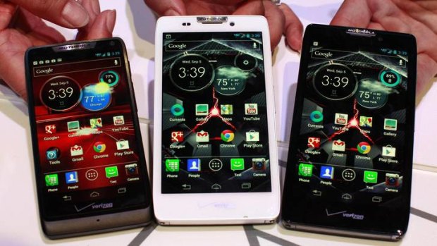 Product specialists display new Motorola droid phones; (L-R)  Razr M, Razr HD and Razr Maxx HD during a launch event in New York.