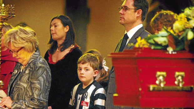 Grandson Louis Bland wears a Collingwood jersey at former Chief Justice John Phillips' state funeral.