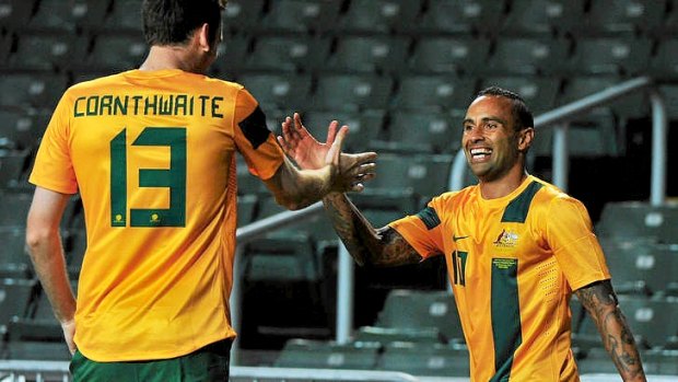 Archie Thompson celebrates with Robert Cornthwaite after scoring for the Socceroos.