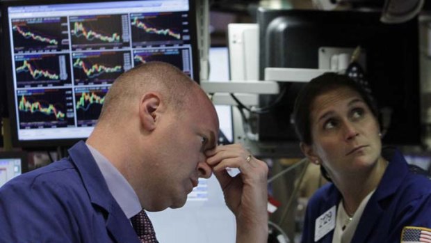 Wall Street tumbles ... traders at the New York Stock Exchange.