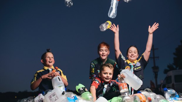 Lake Ginninderra scouts Eli Georgiou, 8, Adrian Lehane, 12, Oliver Georgiou, 6, and Bridget Lehane, 10, with a pile of bottles and cans. Groups like the scouts would benefit from the introduction of an ACT container deposit scheme.