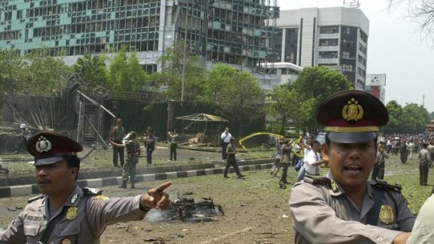 Indonesian police direct people near the embassy on September 9, 2004.