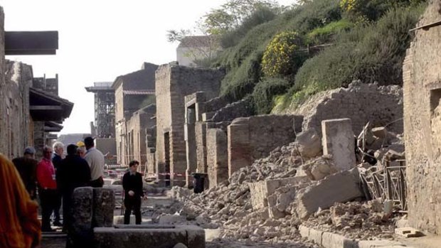 People look at the ruins of the Gladiator domus in the archeological site of Pompeii after the house collapsed on Saturday.