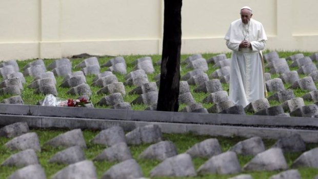 Pope Francis prays by the gravestones of soldiers from nations of the Austro-Hungarian empire, which were on the losing side of the Great War, in northern Italy.