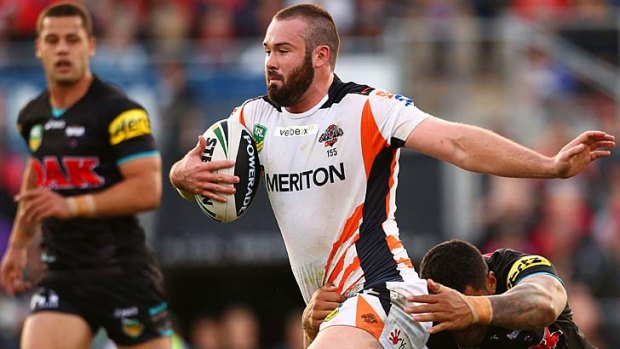 Tearaway Tiger: Aaron Woods goes for a run during the Wests Tigers' upset victory over the Panthers in Penrith.