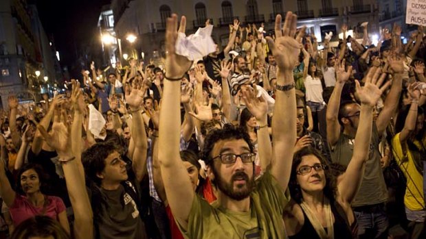 Having their say ... demonstrators raise their hands during the protest in Madrid.