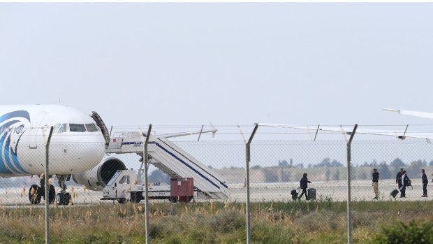Passengers or crew members leave the hijacked aircraft of Egyptair at Larnaca airport.