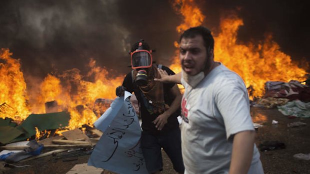 Supporters of Mohamed Mursi run from Egyptian security forces firing towards them during clashes in Cairo's Nasr City.