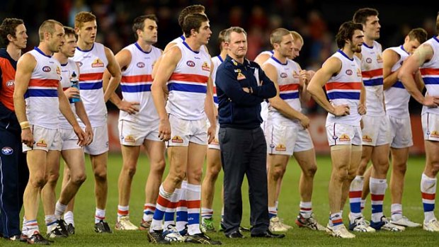 Bulldogs coach Brendan McCartney with his players after their heavy loss to Essendon on Saturday night.