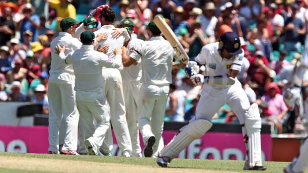 Mitchell Starc celebrates the wicket of Mahela Jayawardene.