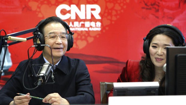 Chinese Premier Wen Jiabao participates in a live broadcast during his visit to the China National Radio in Beijing.