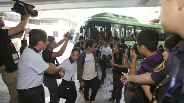 Chinese relatives of passengers on board the missing Malaysia Airlines Flight 370 arrive at a hotel in Subang Jaya, Malaysia, including Jiang, in the green jacket.