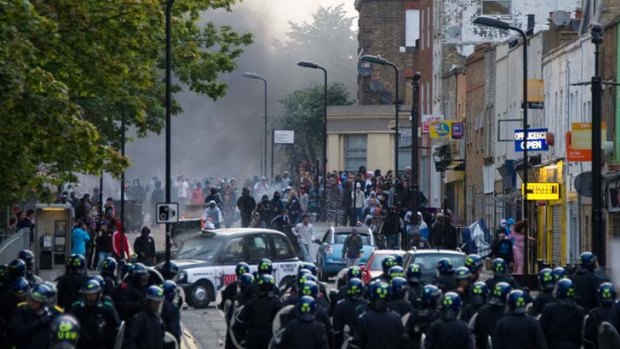 Stand-off ... riot police charge a mob in Hackney on Monday,  the third day of violent civil disorder in the capital.
