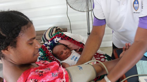 A Port Moresby mother and her newborn get a health check at the Port Moresby General Hospital weekly family planning clinic.